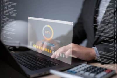 Business continuity expert monitoring a software update on a laptop, with code overlays illustrating system maintenance, patch management, and cyber security updates.